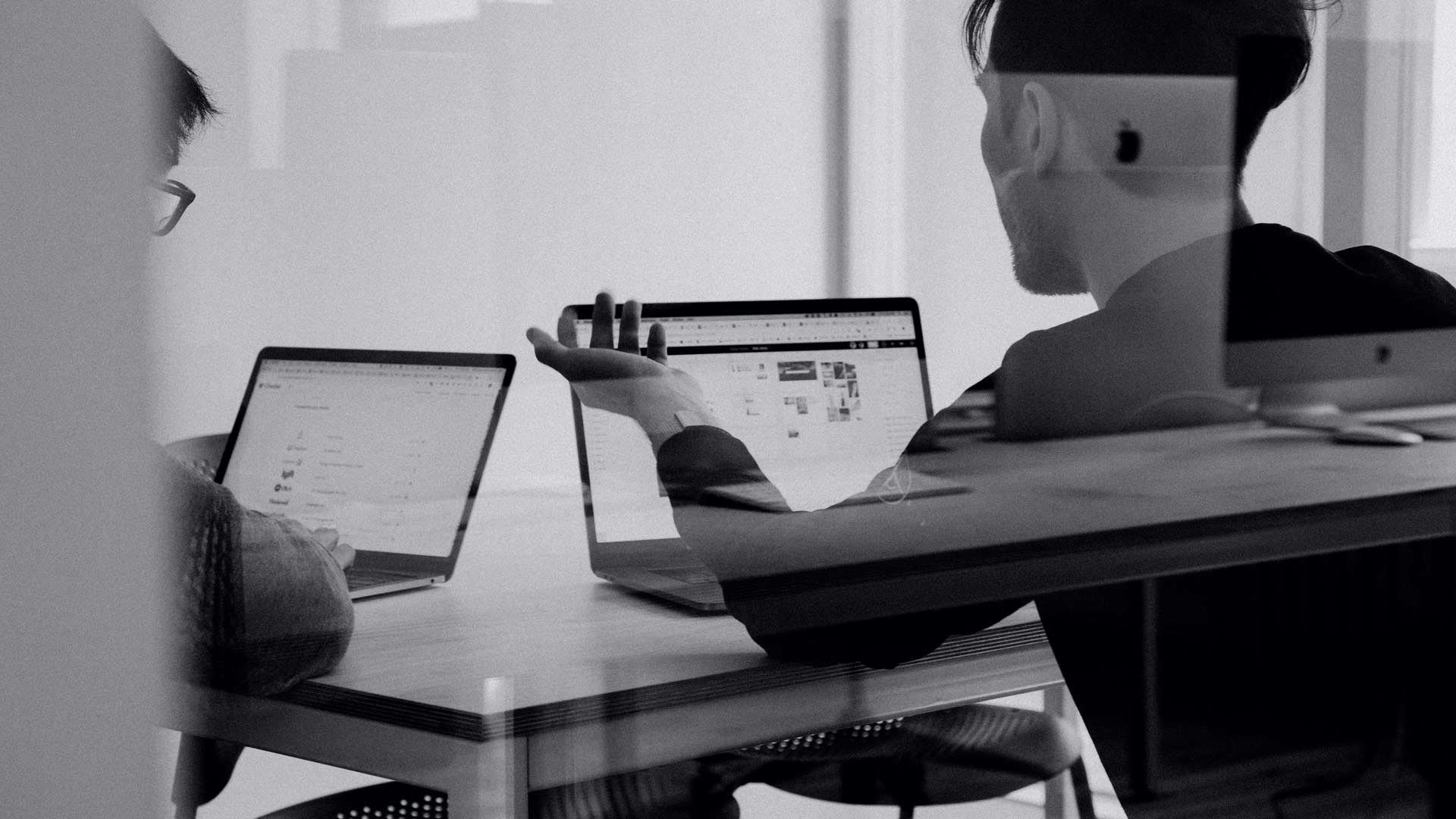 Two People Discussing Strategy in Meeting Room